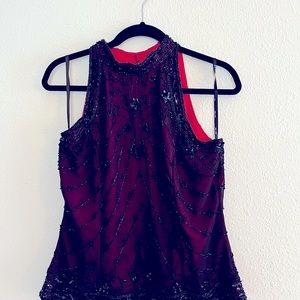Black top with with hint of red which is inner cloth with sparkly beads.